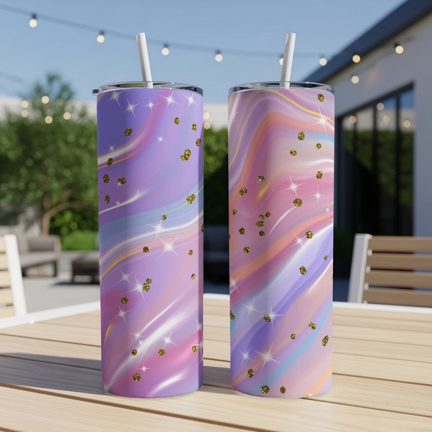 Two tumblers with pastel marble patterns and gold glitter accents on a table.