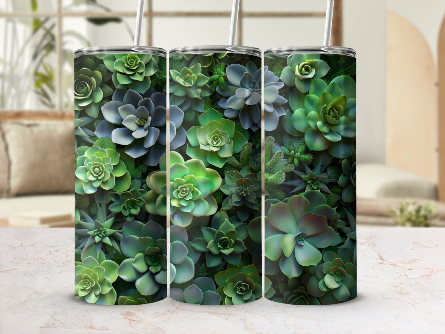 Three tumblers with a dense succulent plant pattern on a marble countertop.