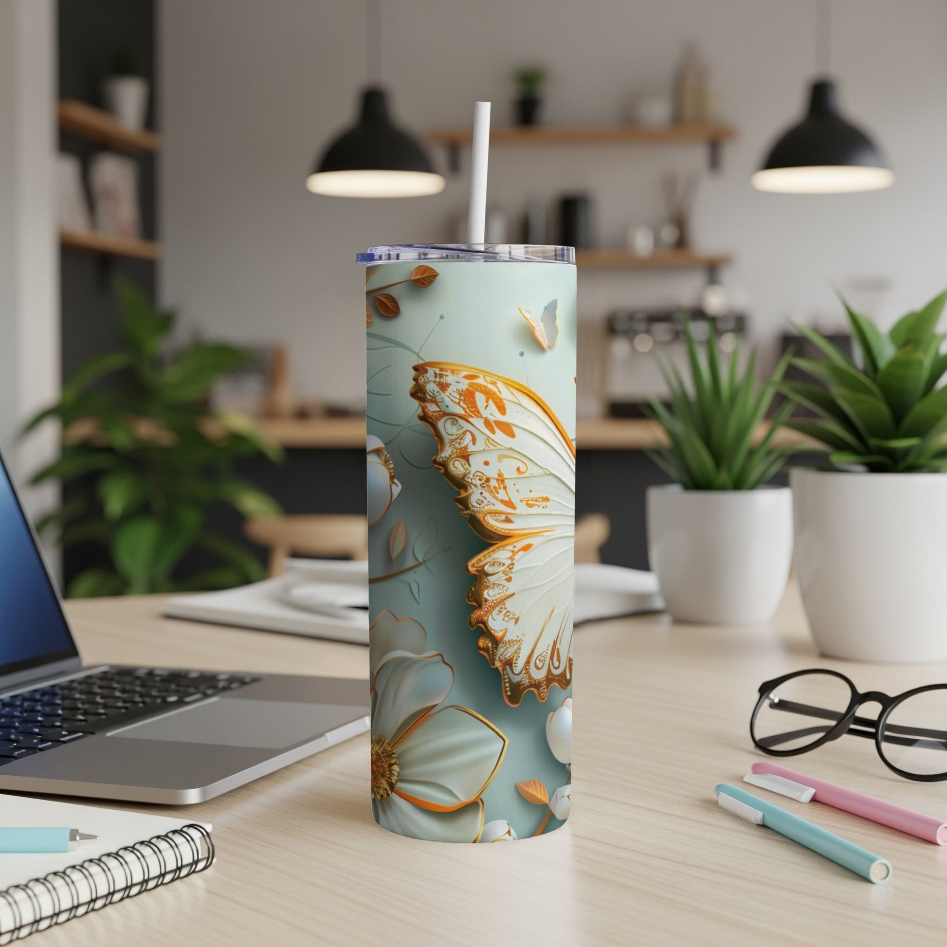 White skinny tumbler with ornate gold and orange butterfly and floral design.