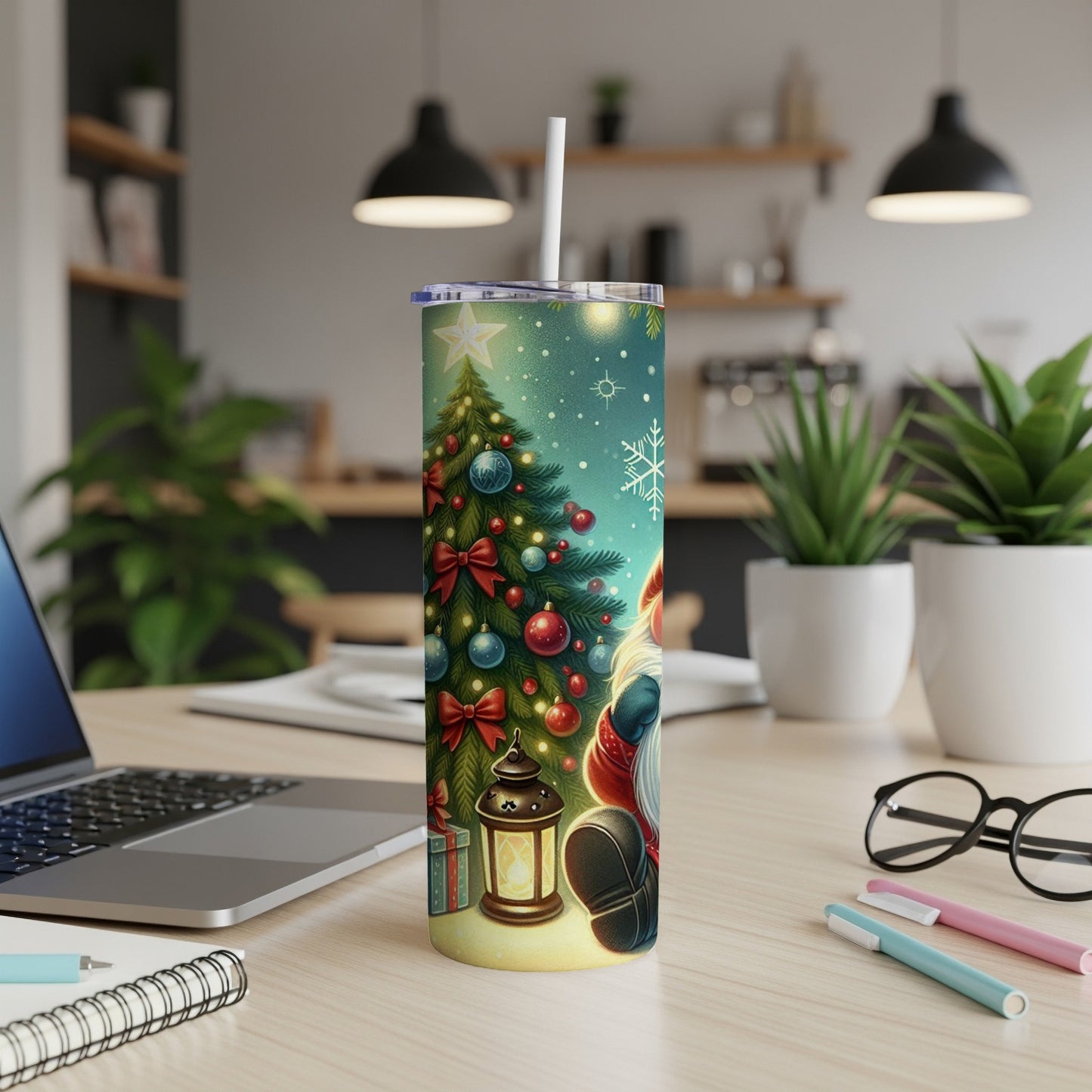 Santa Claus design on a white tumbler with a straw, on a desk.