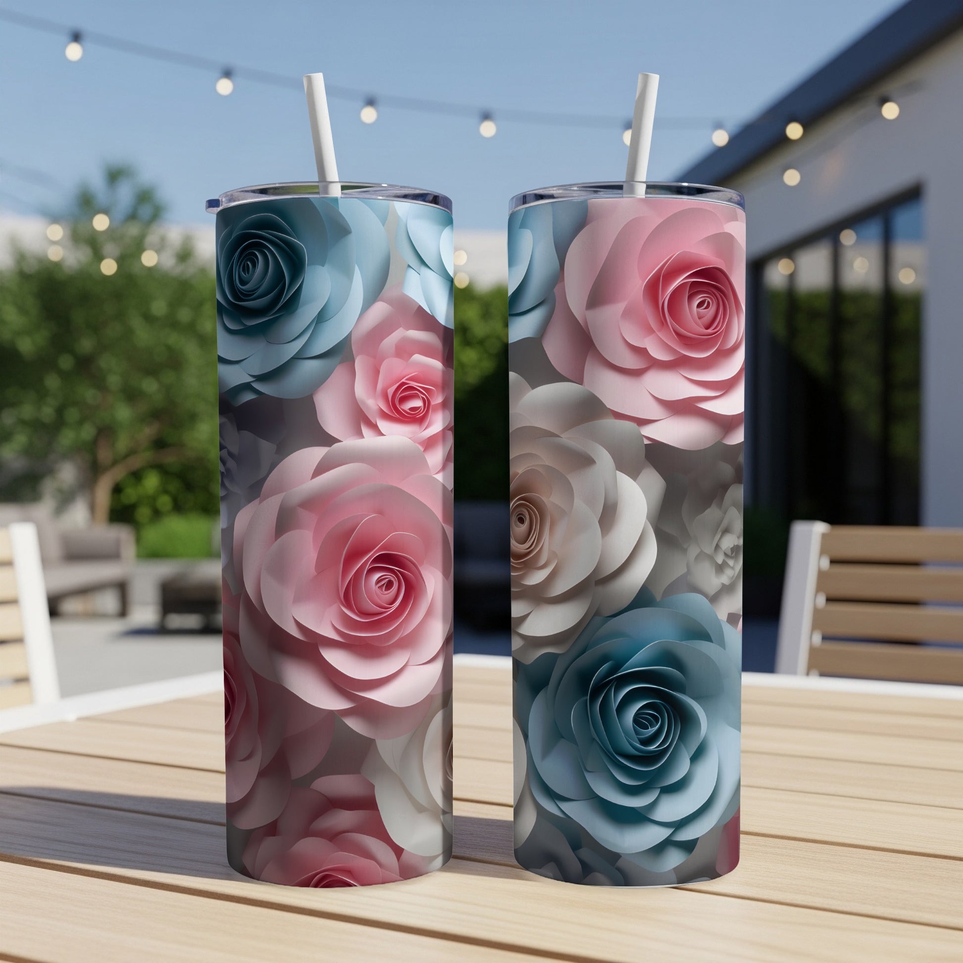 Two tumblers with floral patterns, one blue and pink, the other pink and blue.