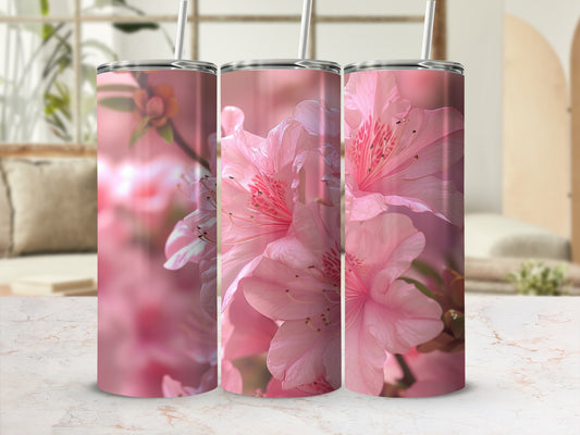 Pink azalea flowers wrap around three skinny tumblers with straws.