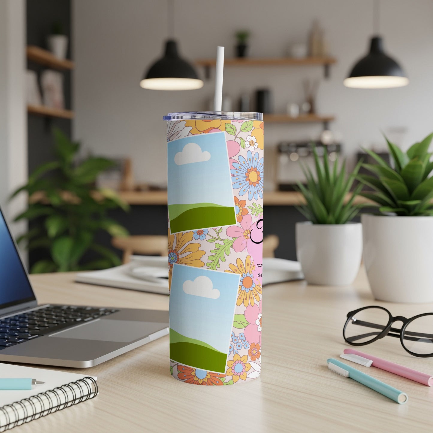 Floral tumbler with photo frames and "CON" text, on a desk.