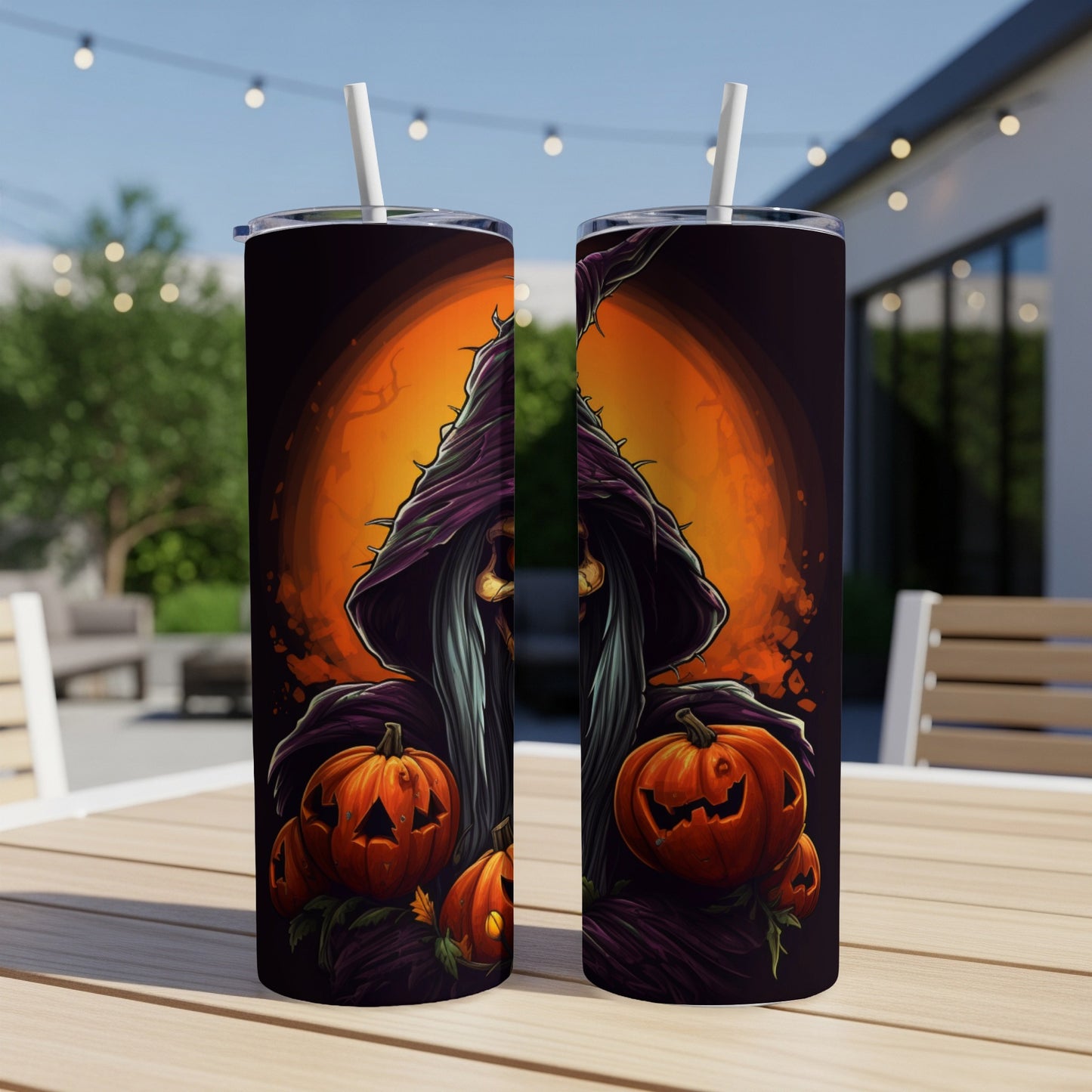 Two tumblers with Halloween witch and pumpkin designs sit on a wooden table.