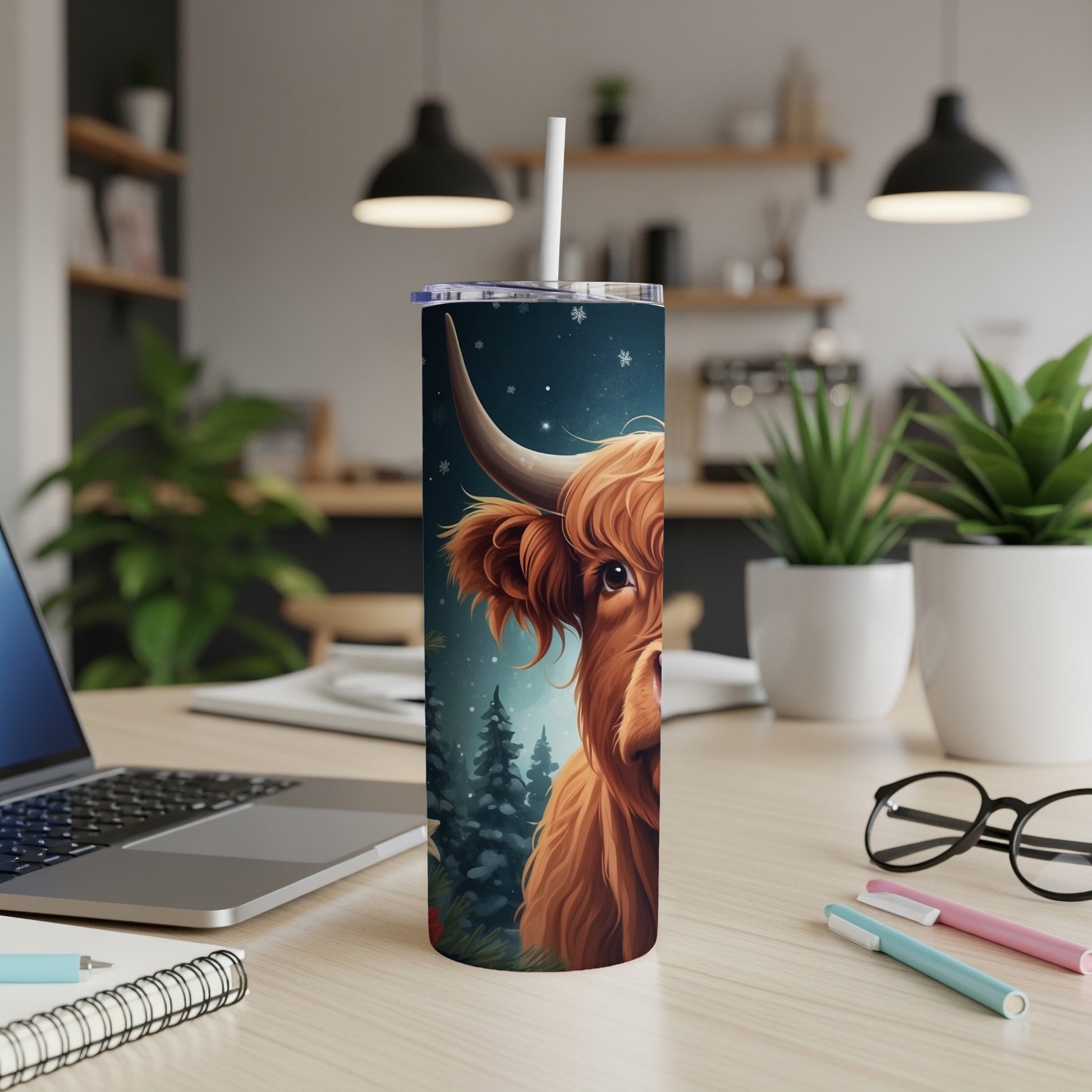 Highland cow on a tumbler with a snowy forest background.