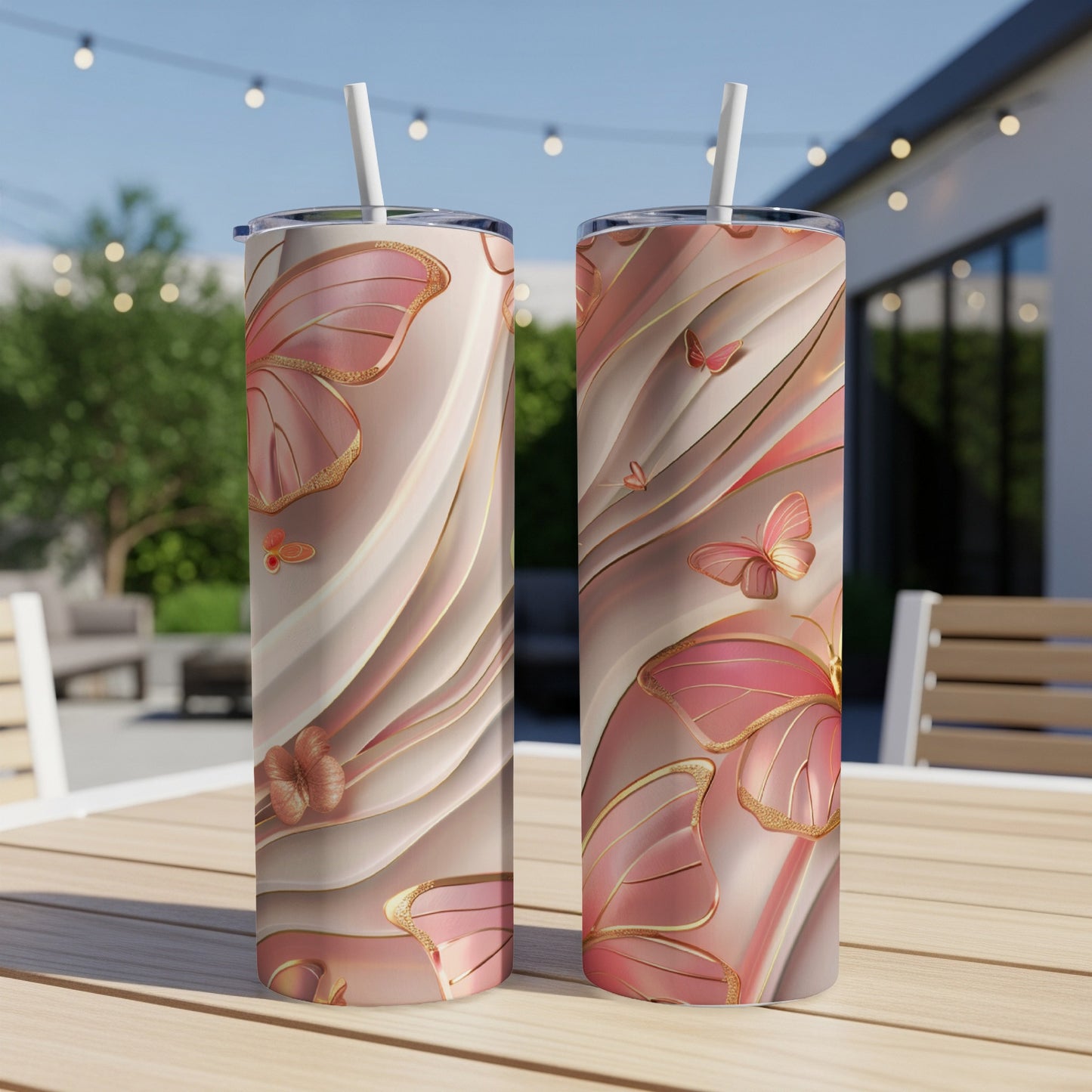 Two pink butterfly tumblers with gold accents on a wooden table.