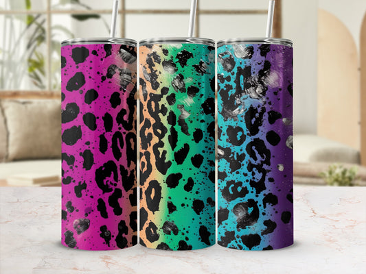 Three leopard print tumblers with rainbow and black paint splatters.