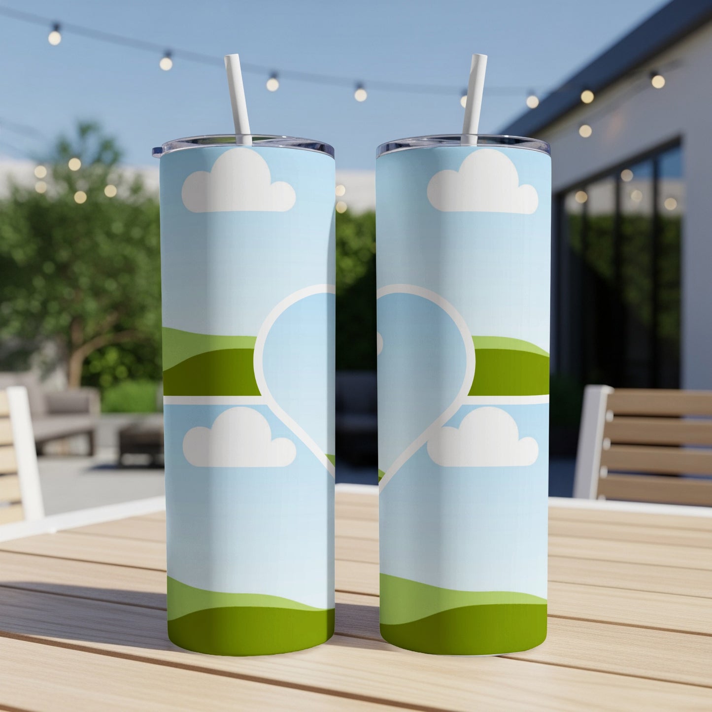 Two tumblers with sky, clouds, and hills design, forming a heart.