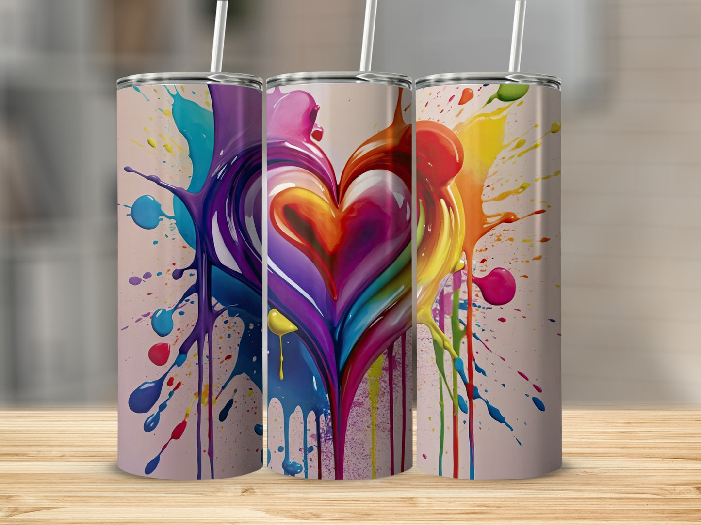Three tumblers with colorful heart-shaped paint splatters.