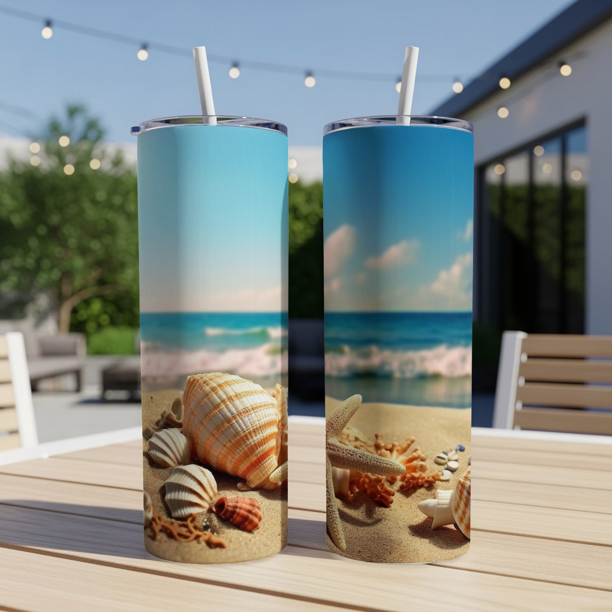 Two tall tumblers with a beach scene, seashells and starfish.