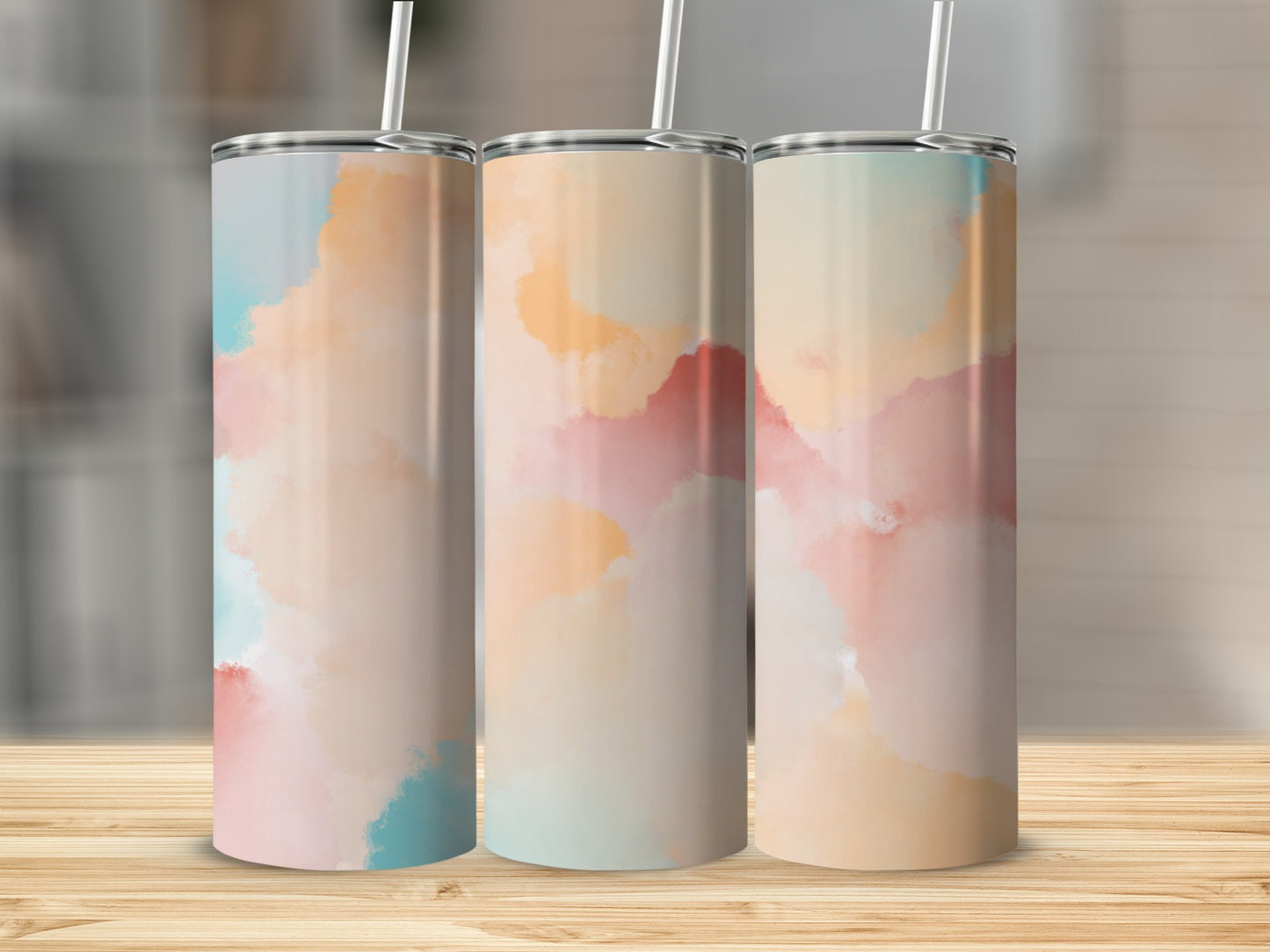 Three tumblers with abstract watercolor patterns in pink, blue, and orange.