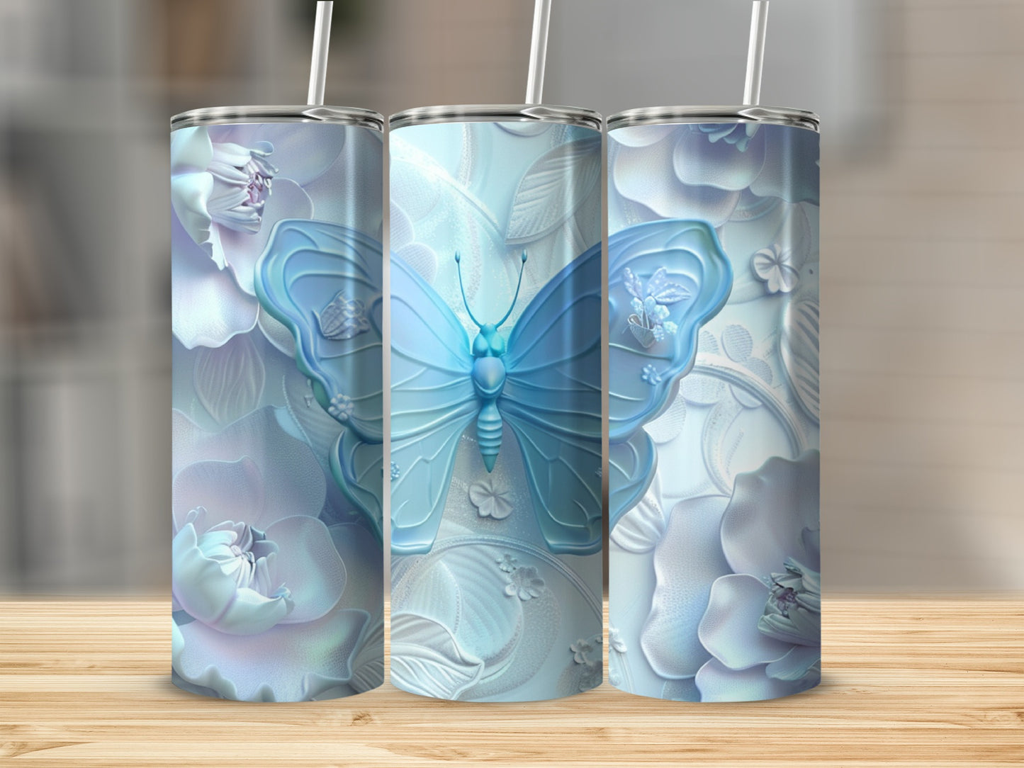 Three tumblers with pale blue butterflies and floral designs.