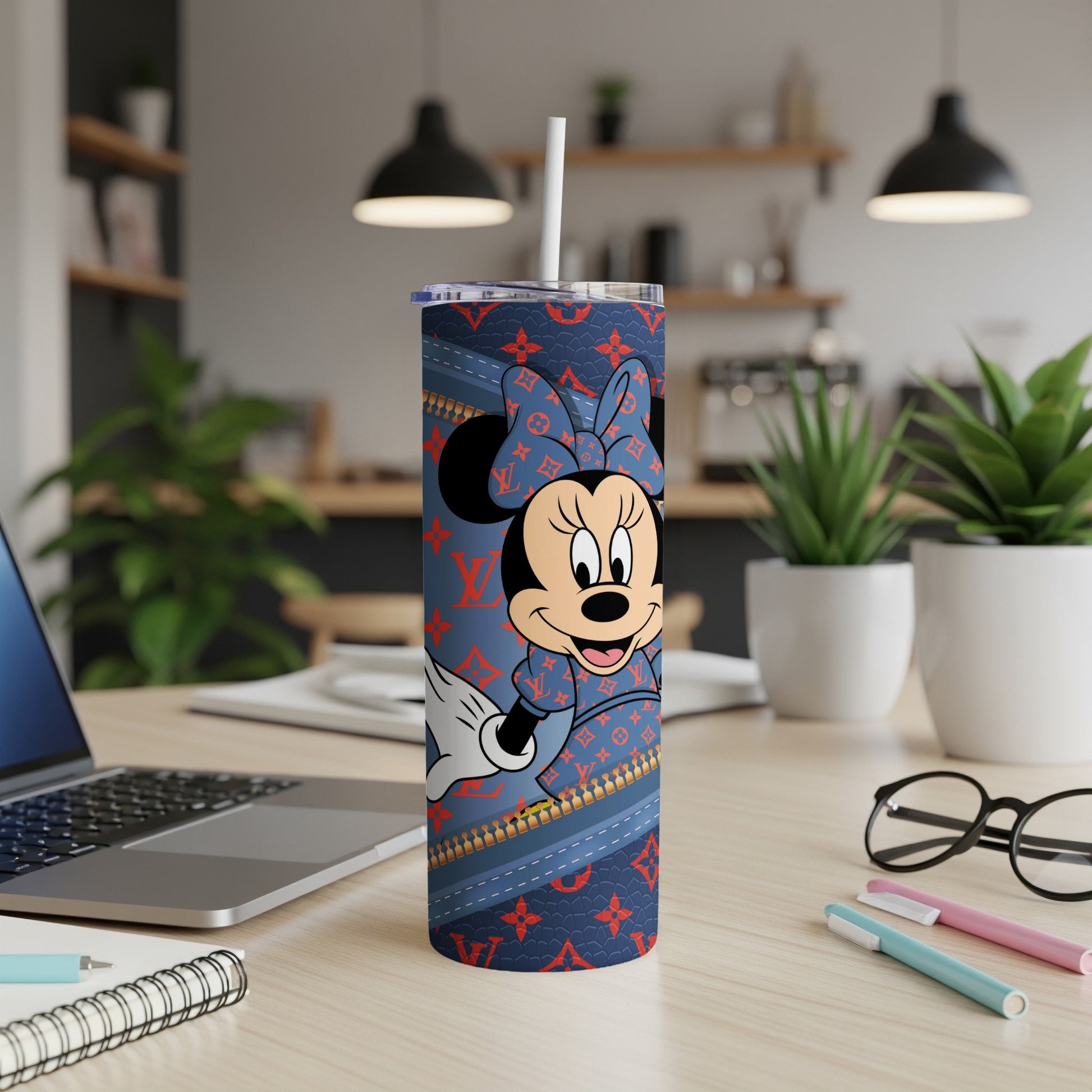 Minnie Mouse on a blue patterned tumbler with a straw.