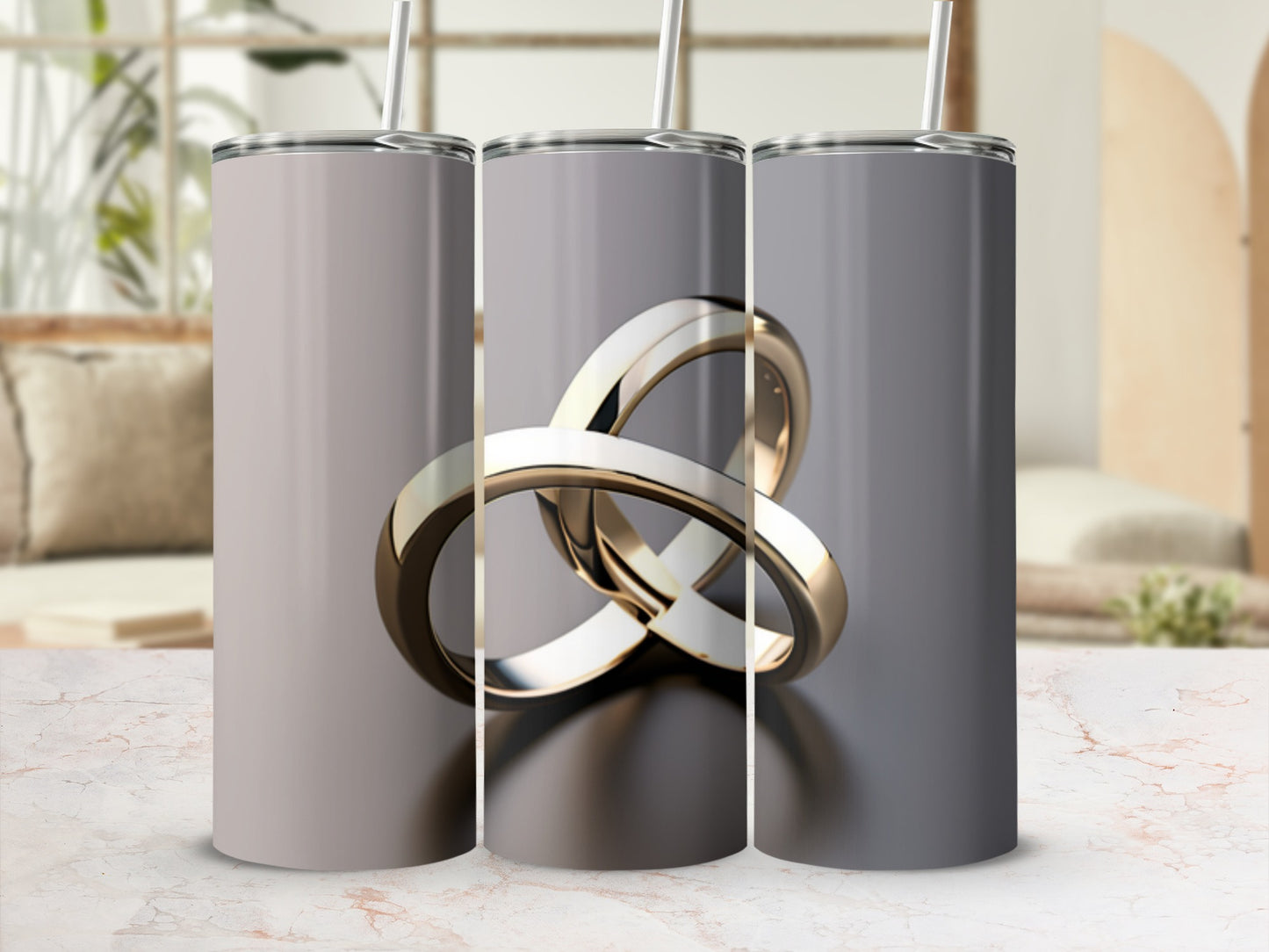 Three silver tumblers with entwined gold rings design.