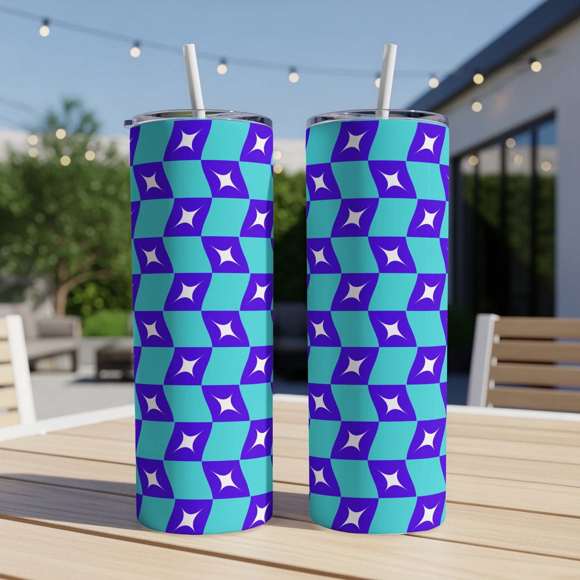 Two tumblers with a blue and purple geometric pattern, each with a white straw.