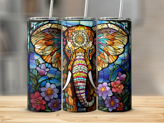 Stained glass elephant tumbler with floral accents on a wooden surface.