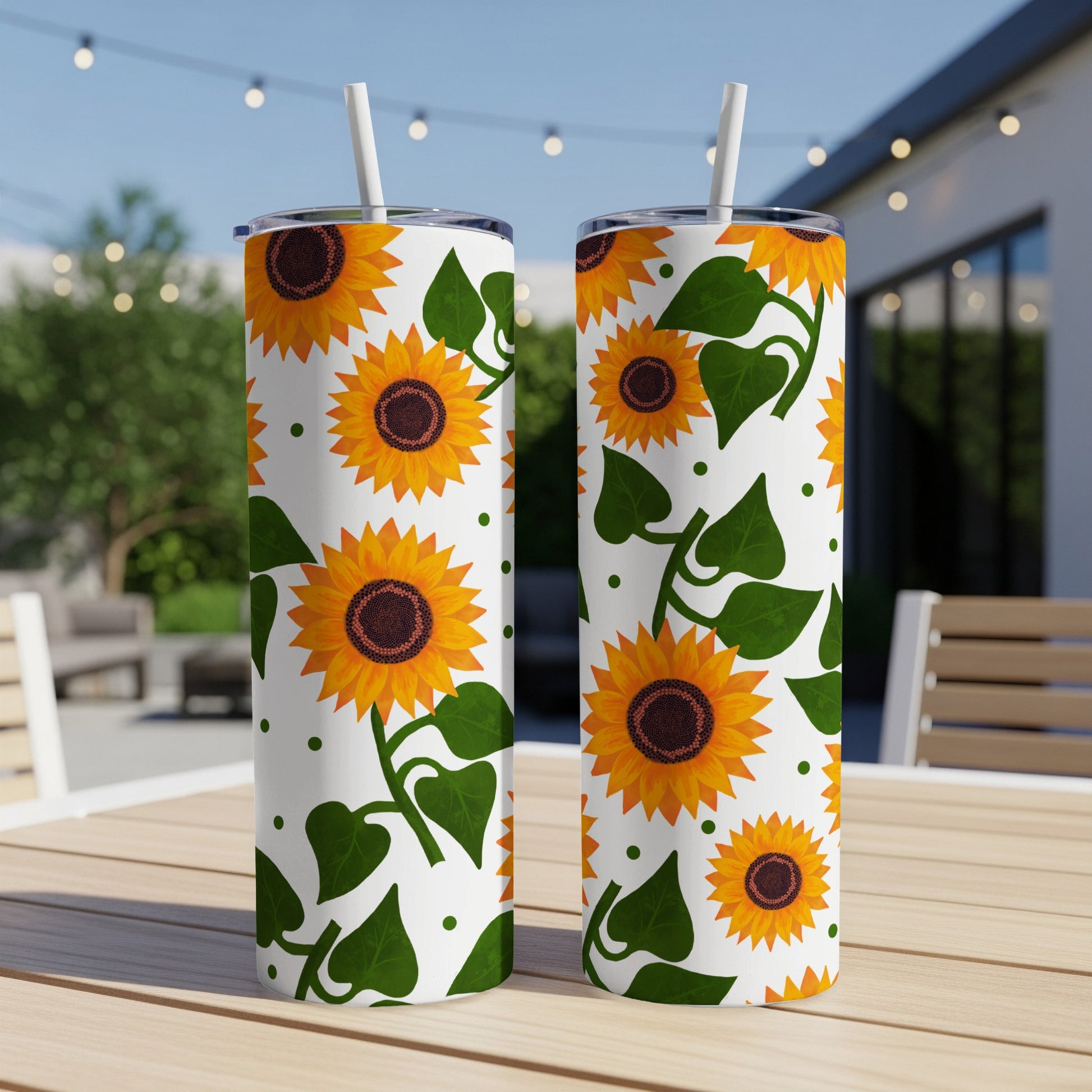 Two white tumblers with a repeating sunflower and green leaf pattern.