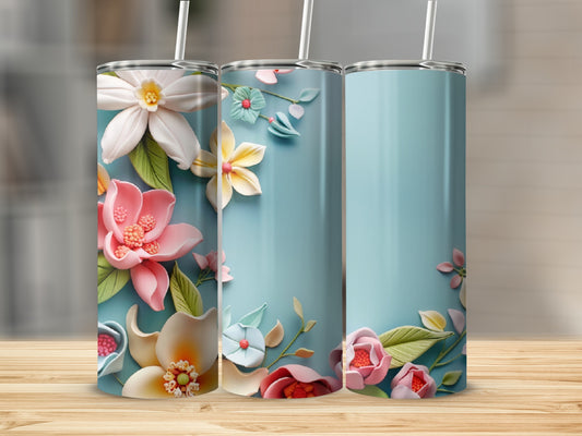 Three tumblers with colorful floral designs on a wooden surface.
