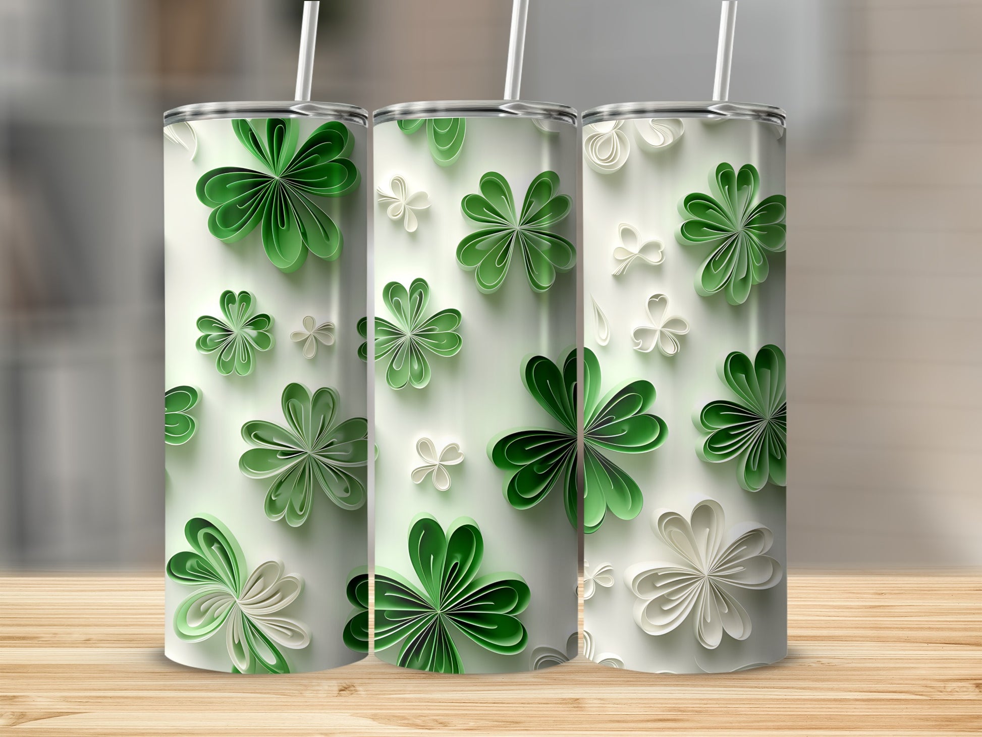 Three tumblers with green and white paper shamrock designs.