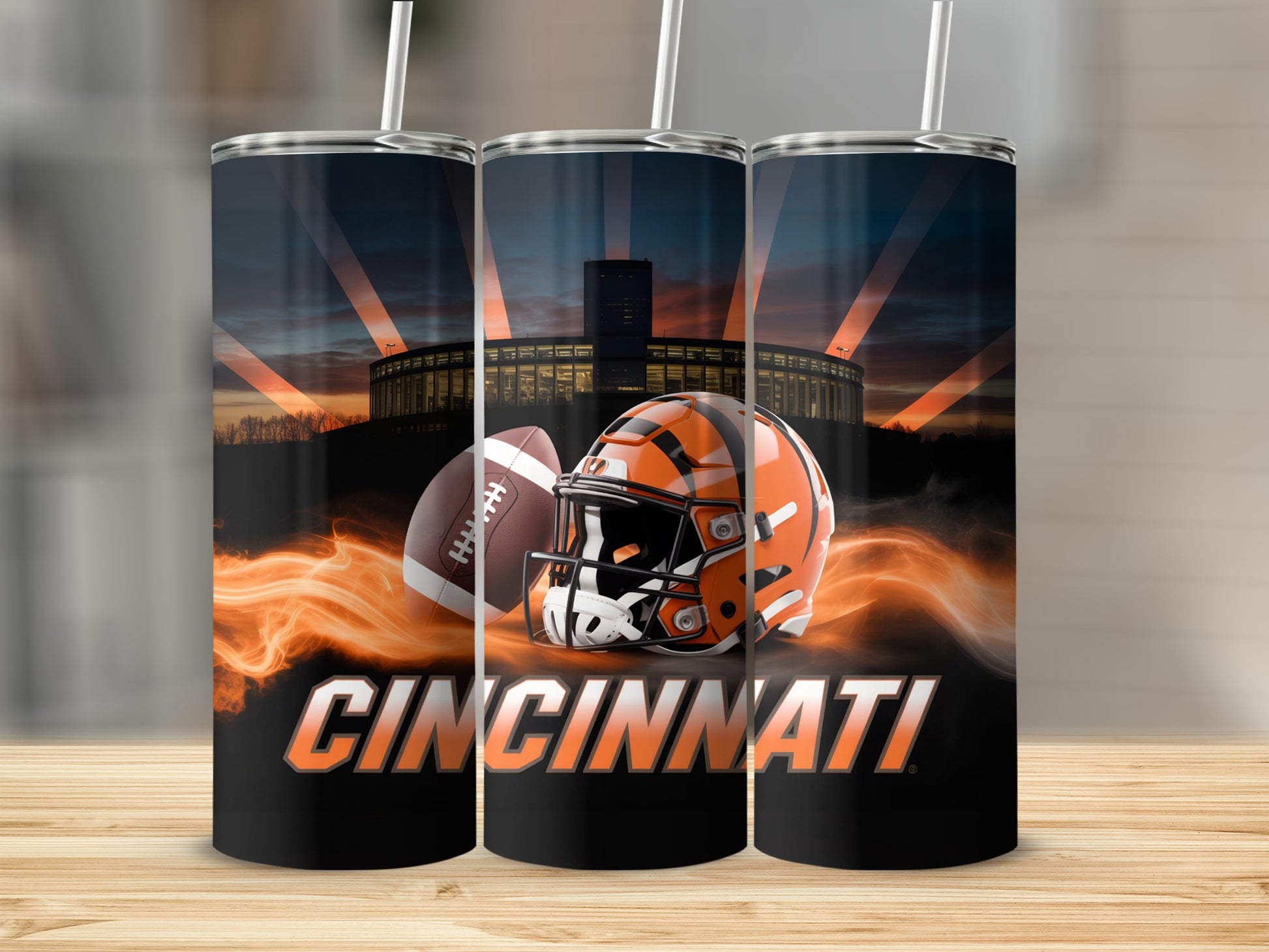 Cincinnati Bengals football helmet and ball with stadium in background.