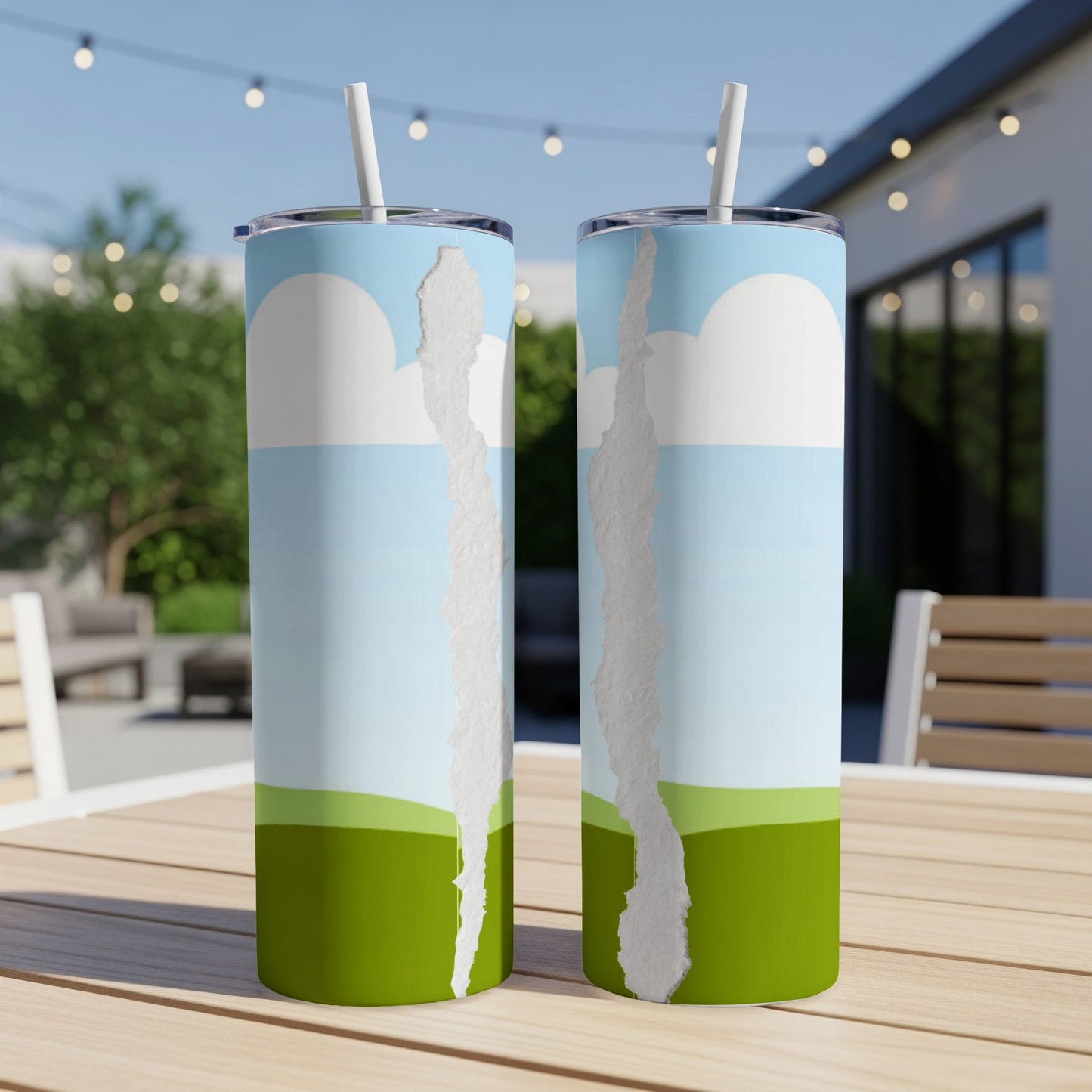 Two tumblers with ripped paper graphic on sky and grass pattern.
