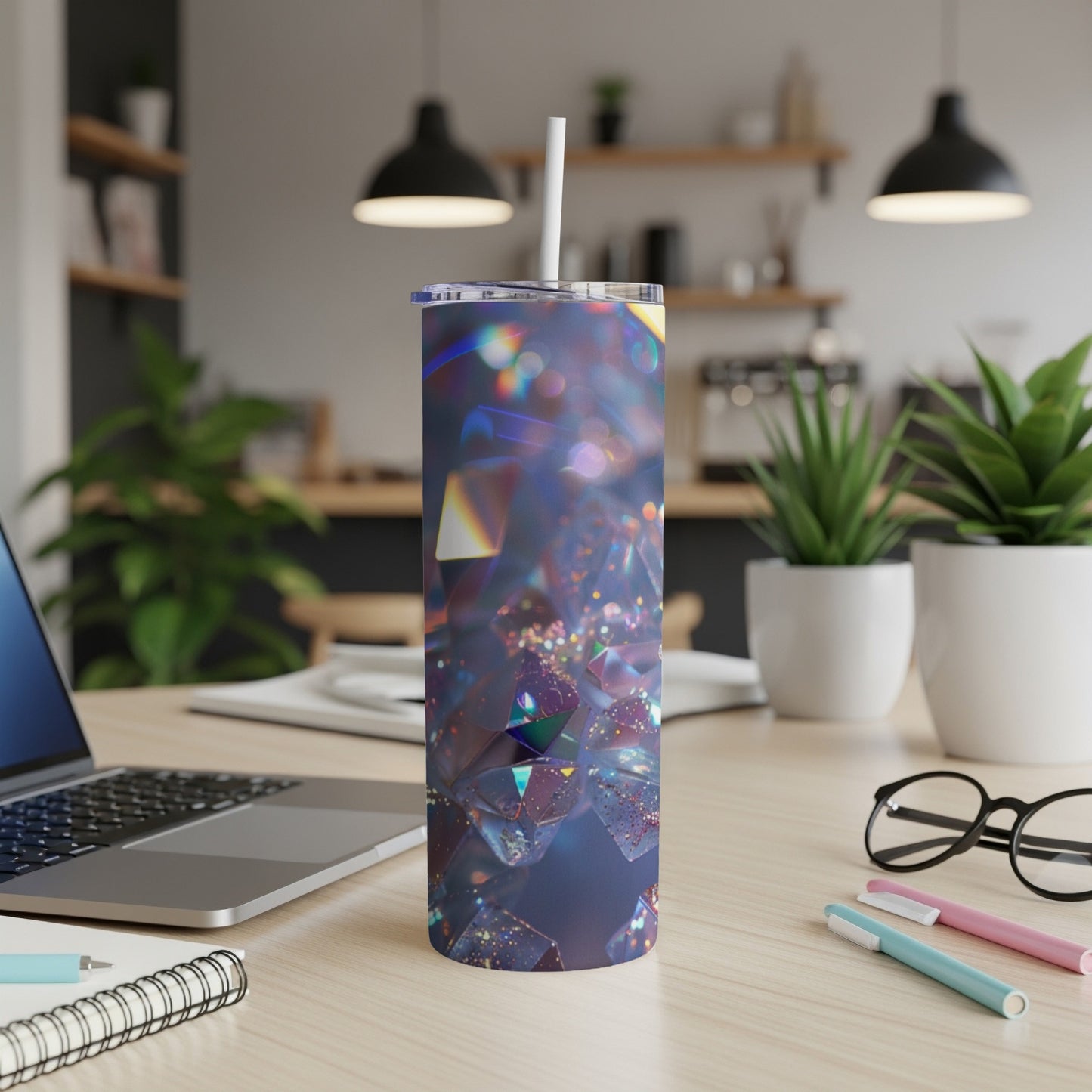 Tumbler with geometric, iridescent crystal pattern, on a desk.