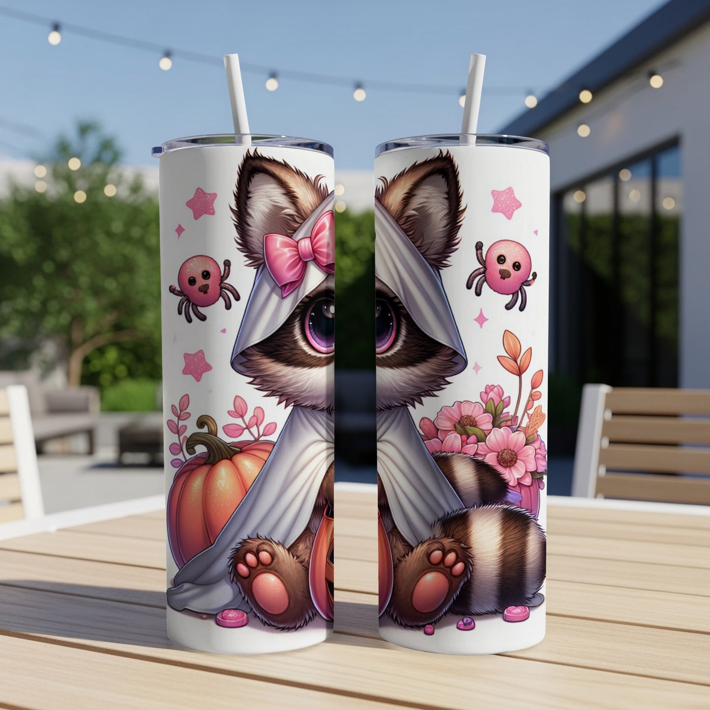 Two tumblers with cute raccoon Halloween design, pumpkins, flowers, and spiders.