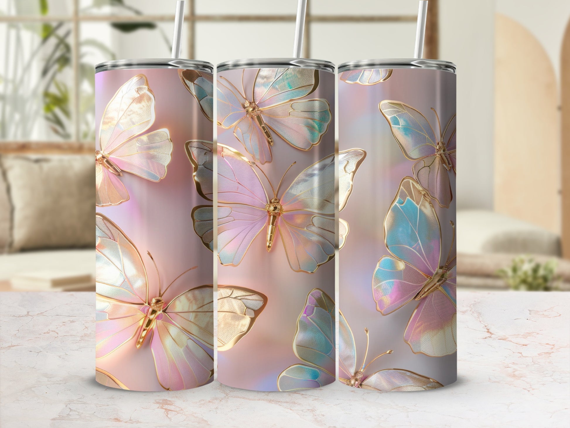 Three iridescent butterfly tumblers with straws on a marble surface.