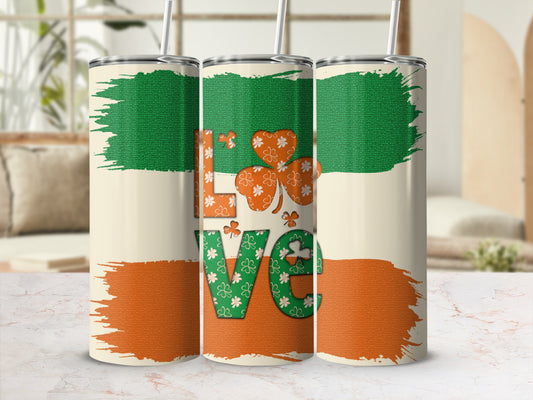 Green and orange shamrock "LOVE" design on a beige tumbler.