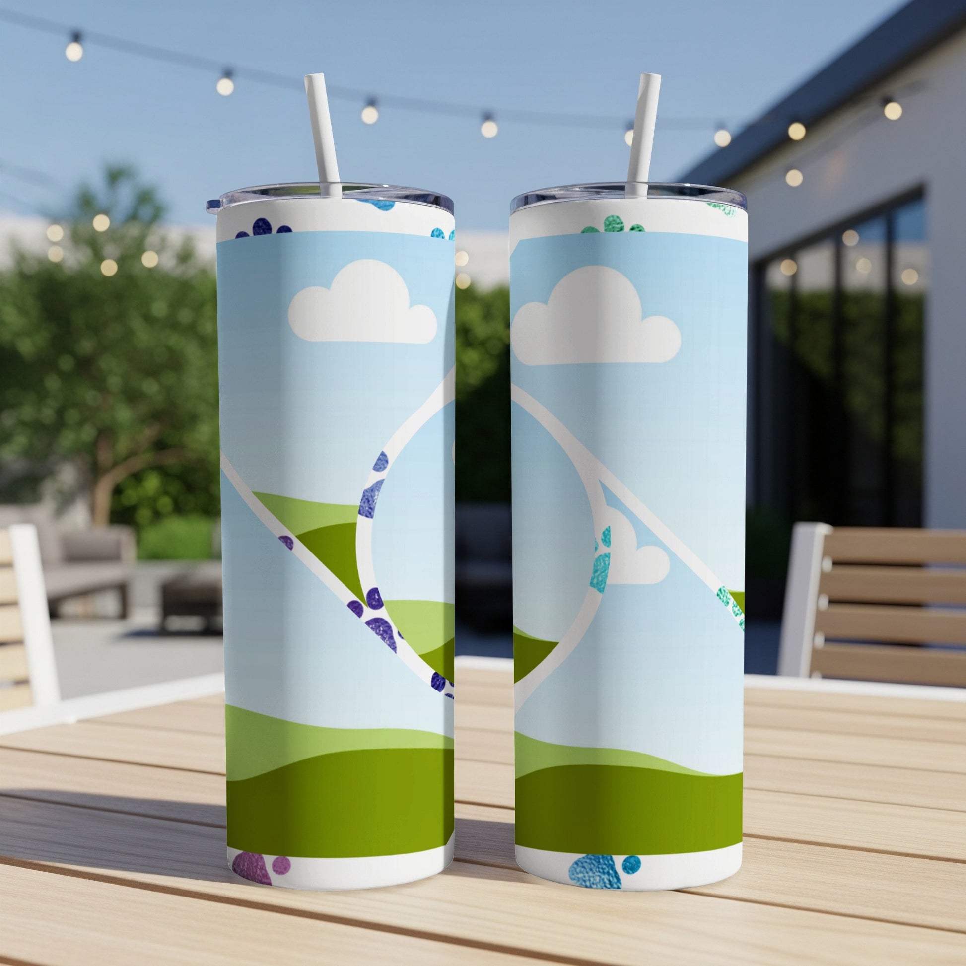 Two tumblers with a sky, clouds, and rolling green hills pattern.