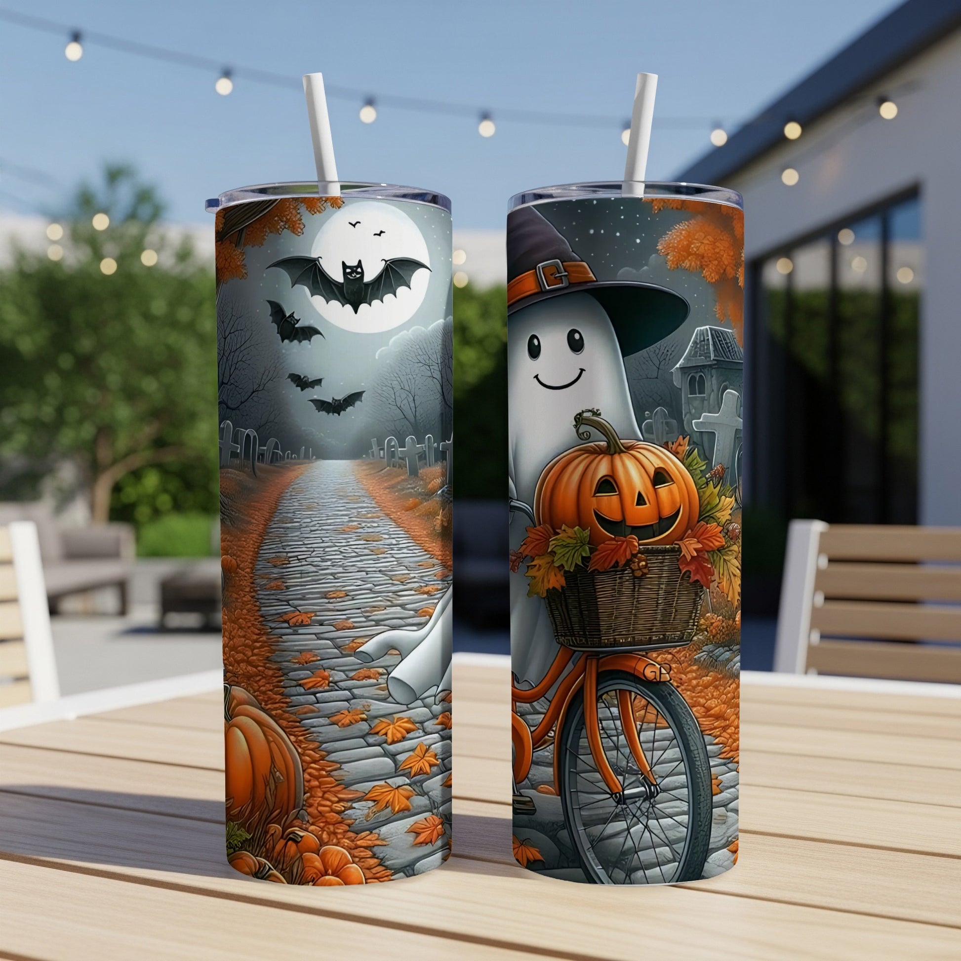 Two tumblers with Halloween designs featuring bats, ghosts, pumpkins, and a bicycle.