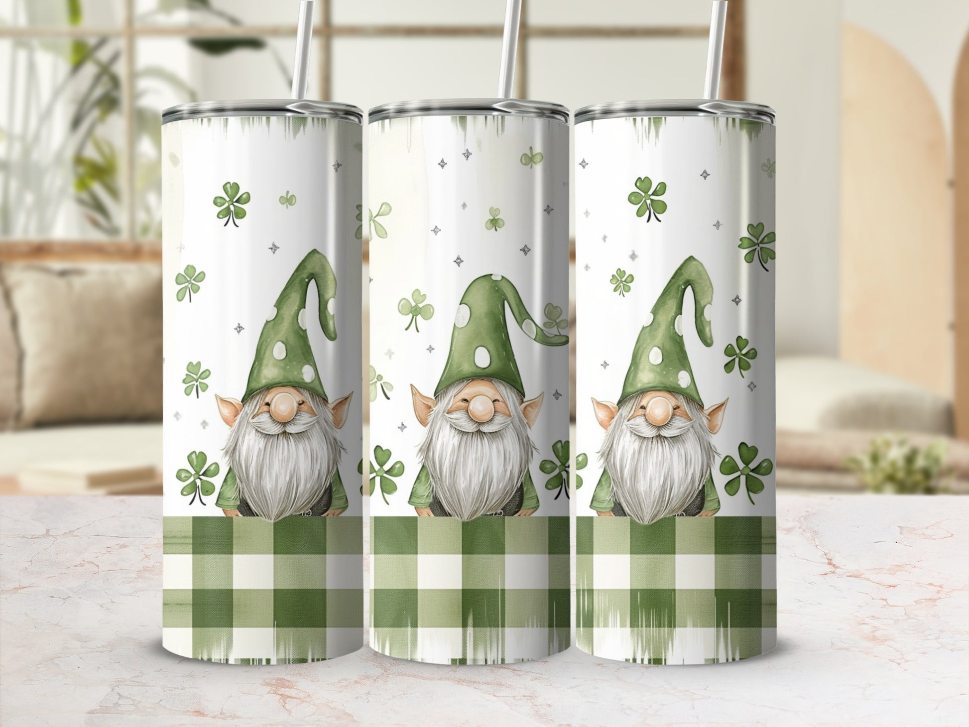 Three tumblers with gnomes and shamrock patterns, on a marbled surface.