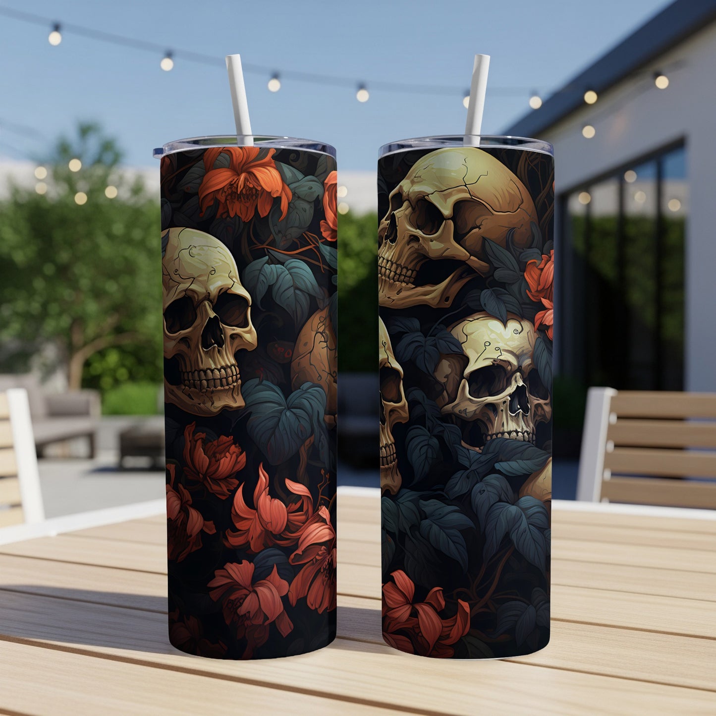 Two tumblers with skulls and red flowers on a dark leafy background.