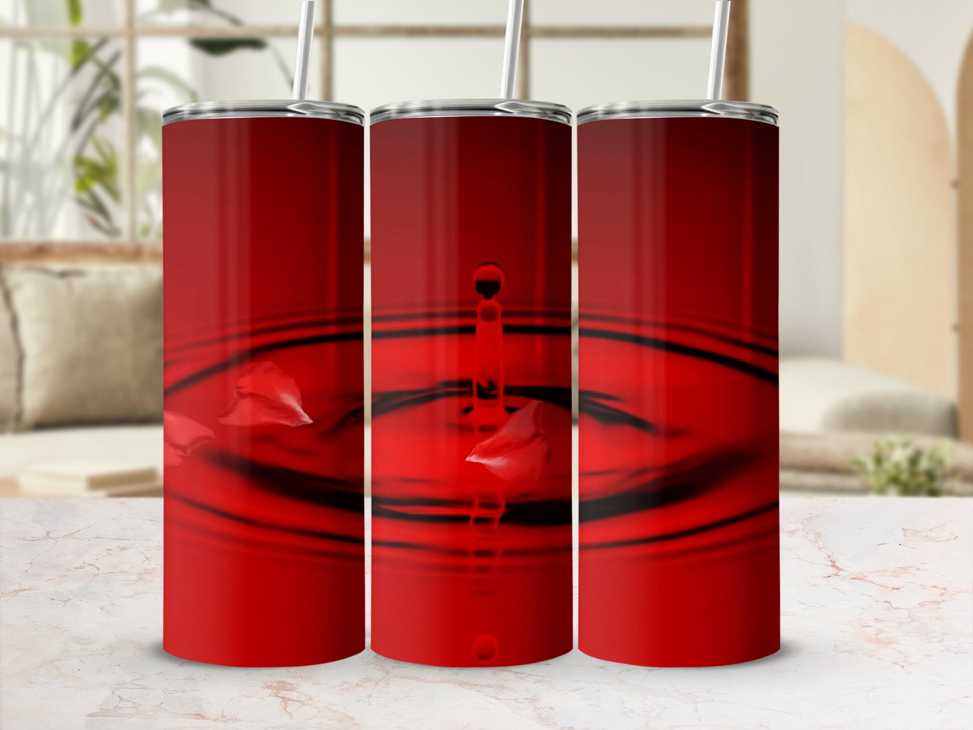 Three red tumblers with water droplet and petal graphics.