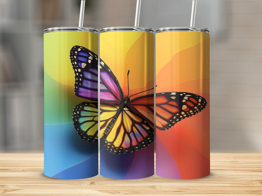 Three tumblers with a colorful butterfly design on a wooden surface.