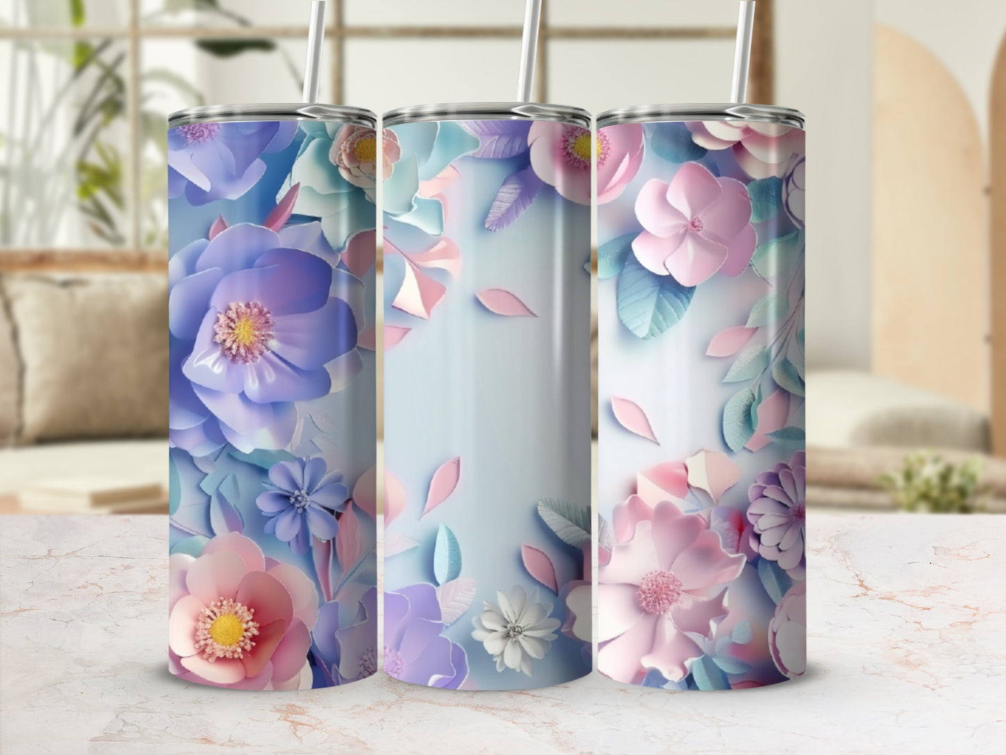Three tall tumblers decorated with pastel floral paper cutouts.