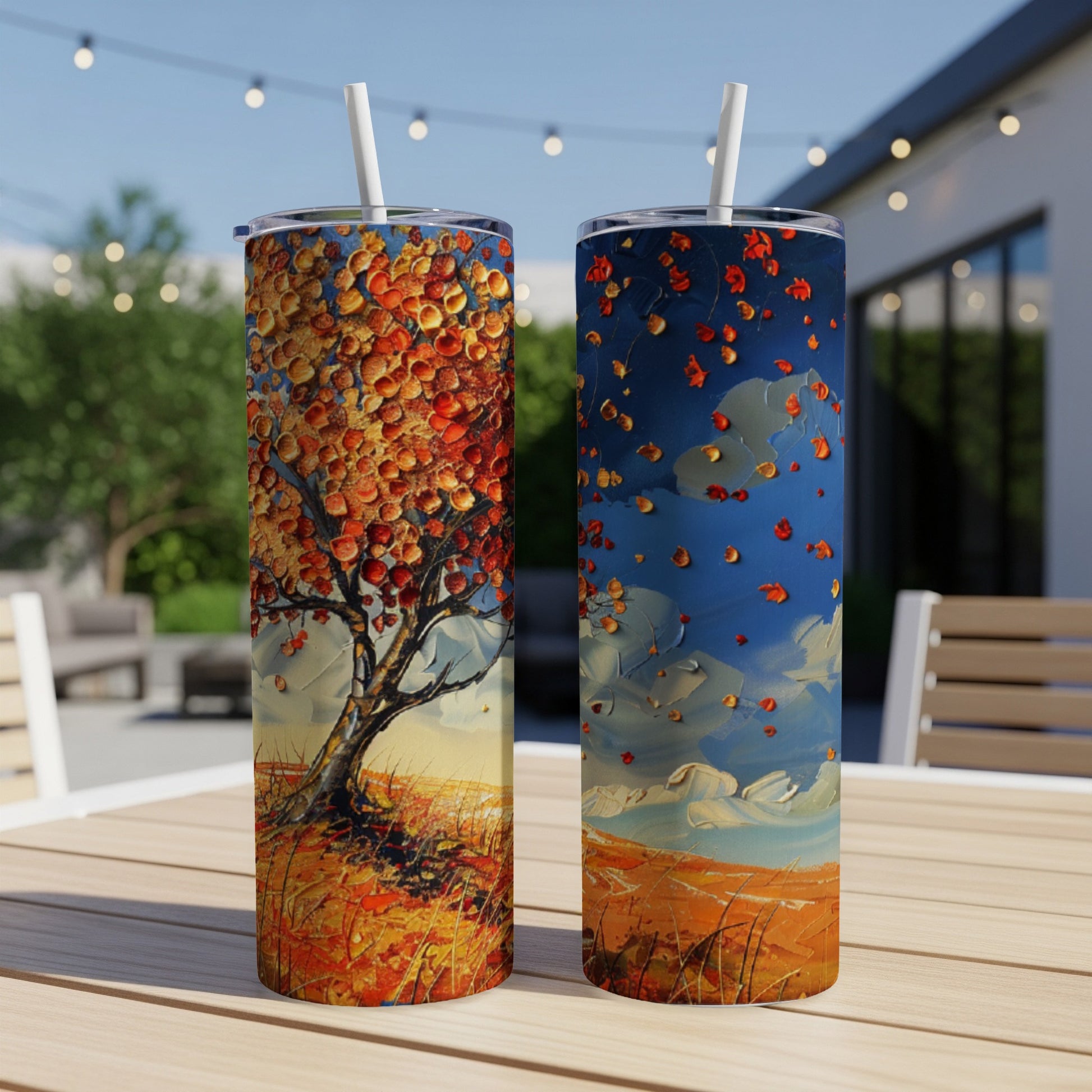 Two tall tumblers with Impressionist style autumn tree artwork.