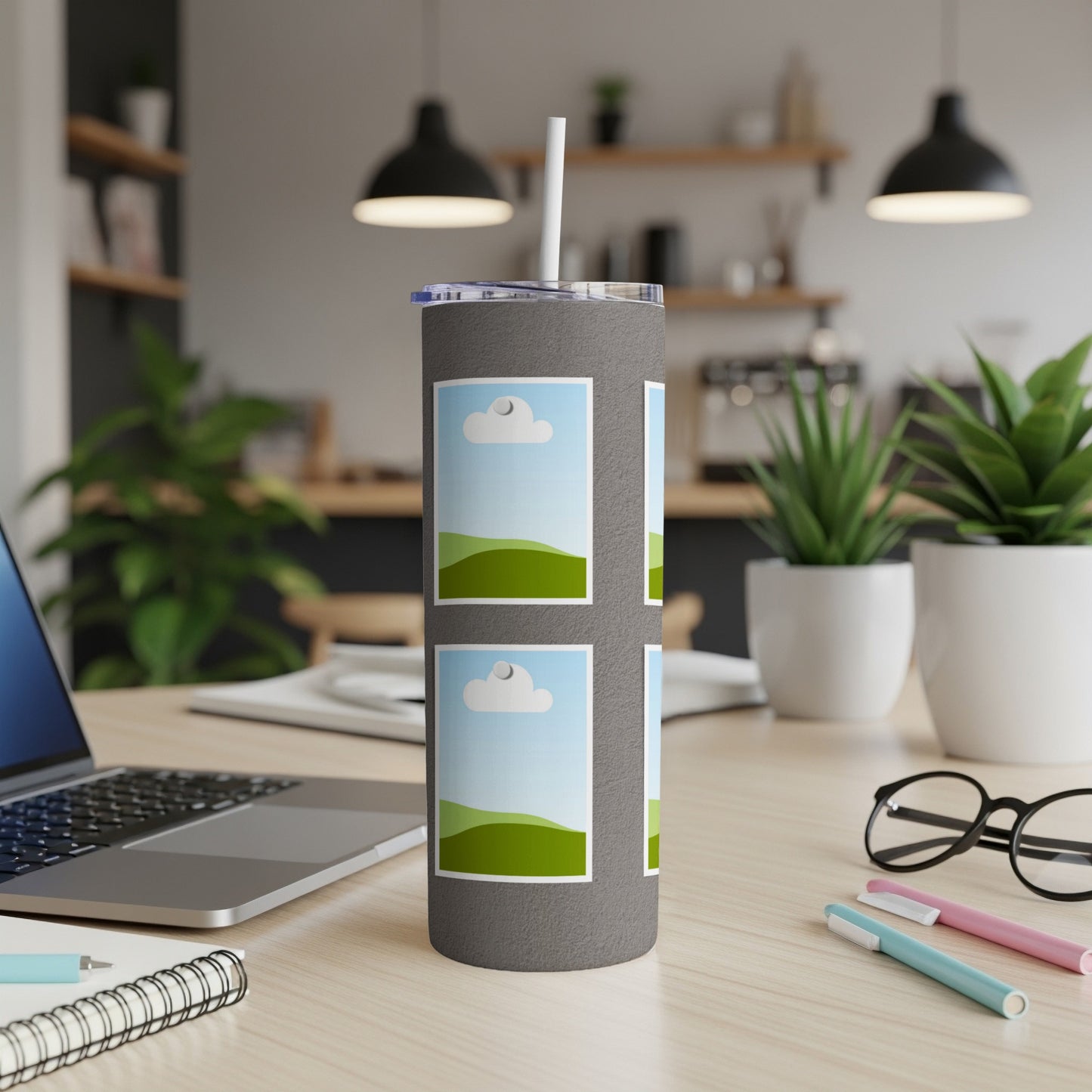 Gray tumbler with attached straw, featuring four framed images of landscapes.