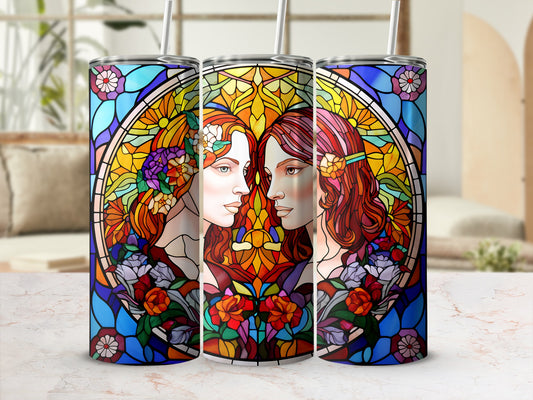 Stained glass tumbler with twin women's profiles and floral accents.