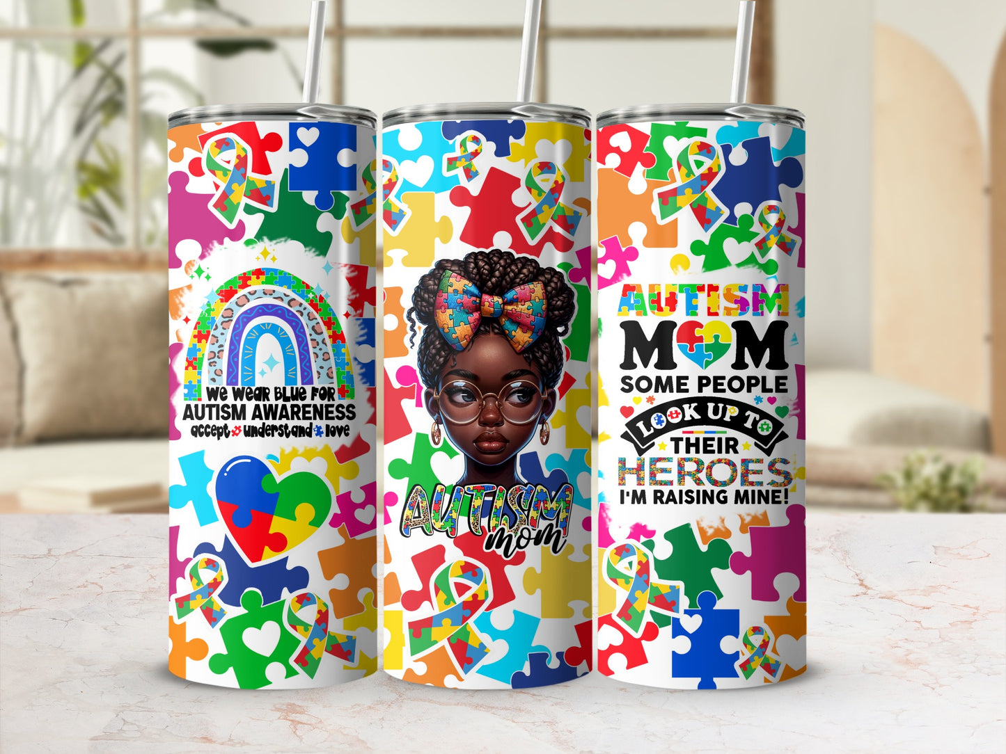 Autism Awareness tumbler with puzzle pieces, rainbow, and "Autism Mom" text.