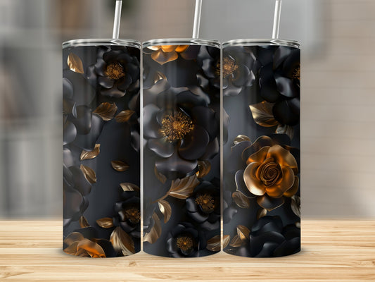 Dark floral tumbler with gold accents and straws on a wooden surface.
