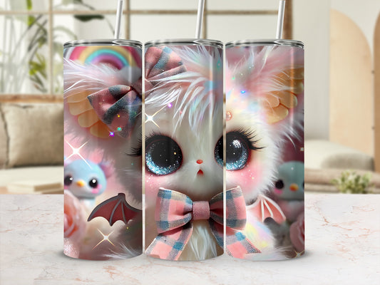 Cute fluffy kitten with large blue eyes and pink bow on a tumbler.