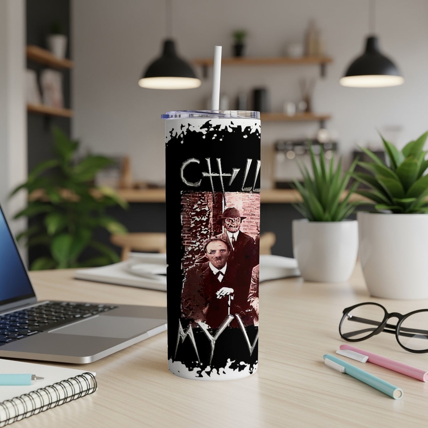 Black tumbler with "CHLL" and spooky figures against a brick wall.