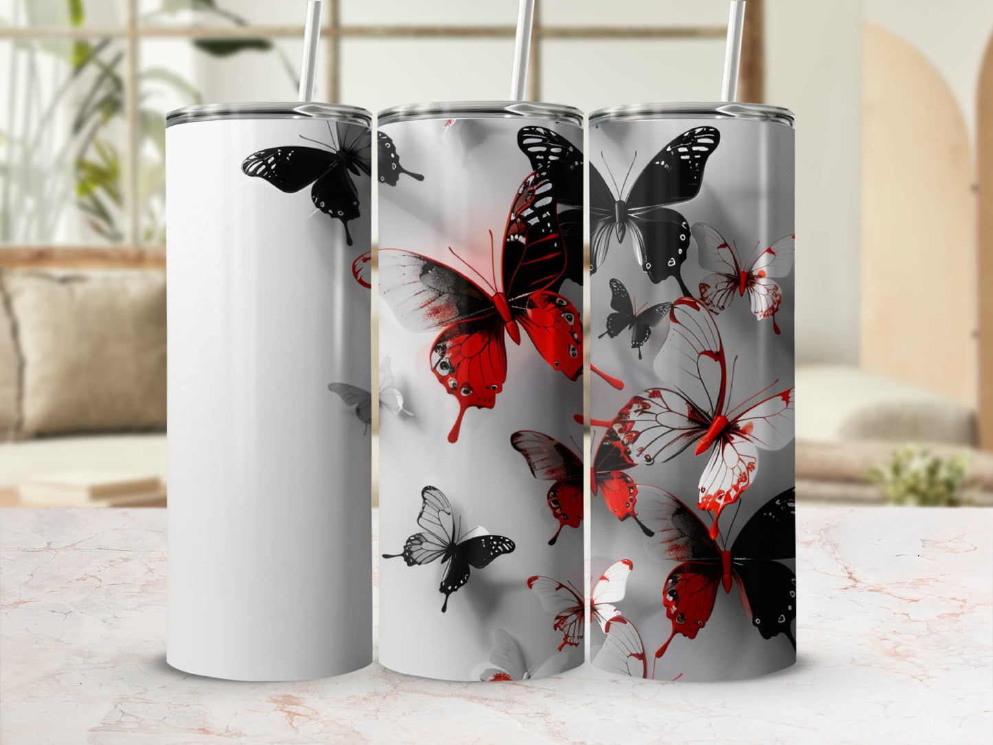 White tumbler with red and black butterfly pattern, with straws.