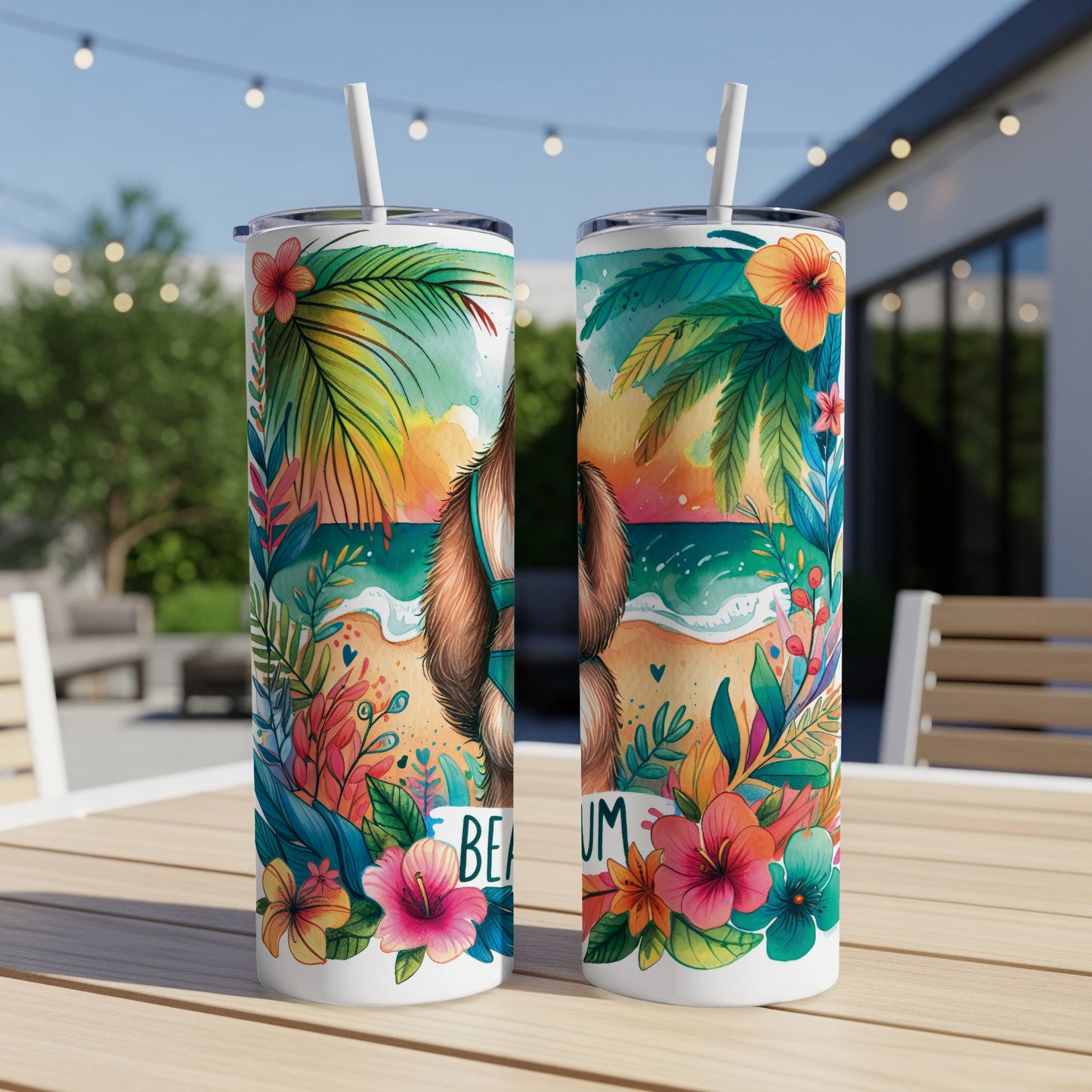 Two tumblers with a beach scene and floral decorations.