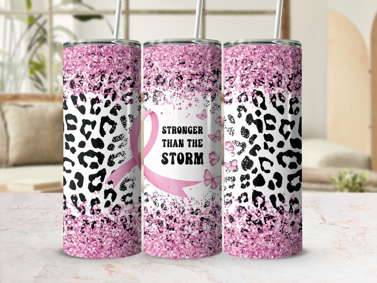 Pink leopard print tumbler with "Stronger Than the Storm" text and butterflies.