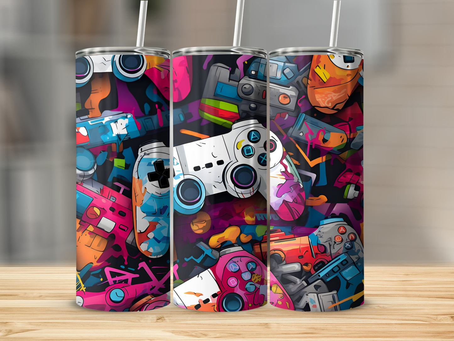 Gaming controllers and vibrant abstract shapes on three tumblers.