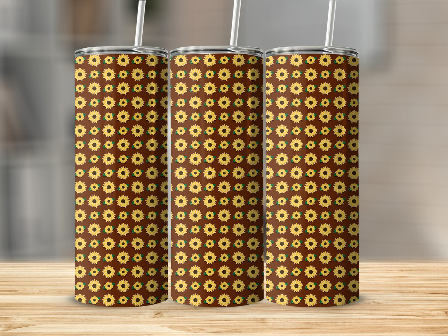 Three tumblers with a repeating pattern of sunflowers on a brown background.
