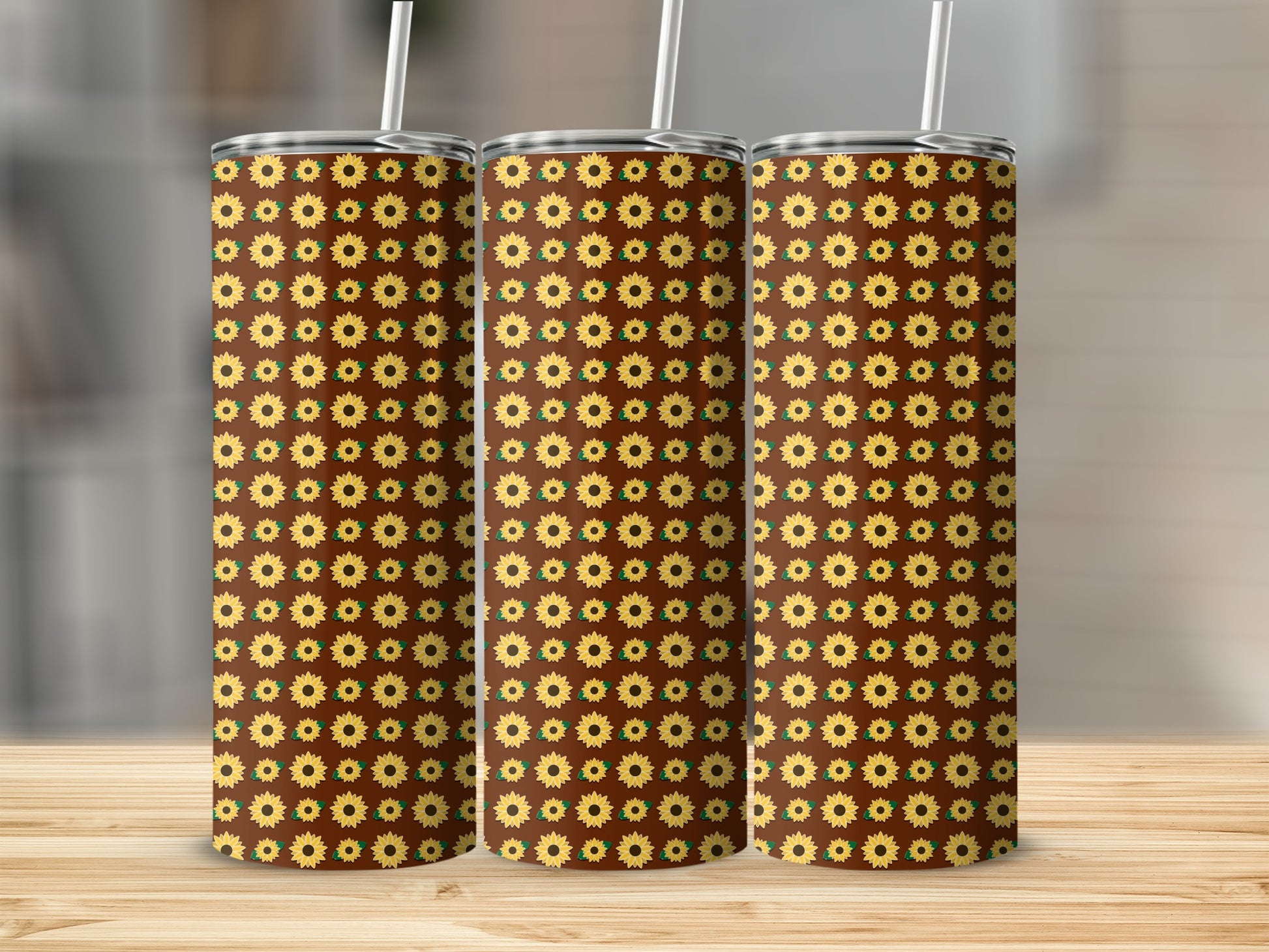 Three tumblers with a repeating pattern of sunflowers on a brown background.