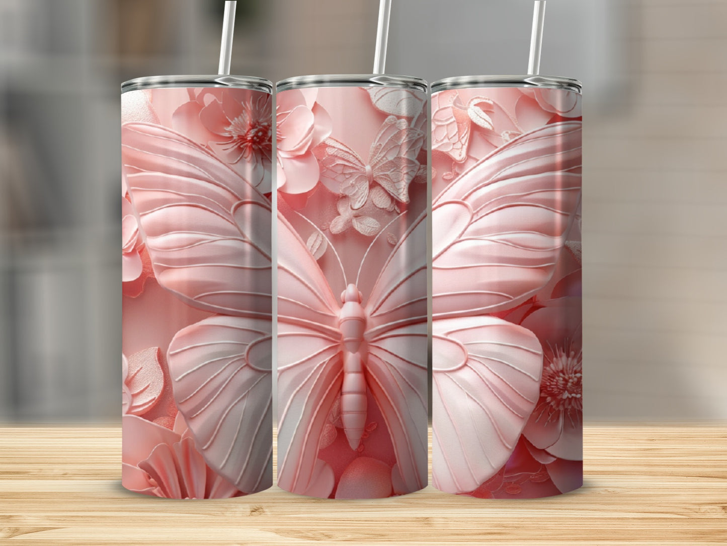Three pink tumblers featuring embossed butterflies and floral designs.